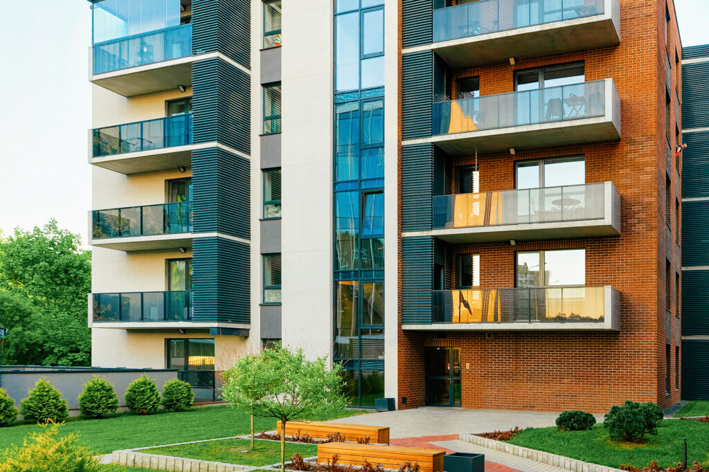 Modern glass and brick apartment block in green area